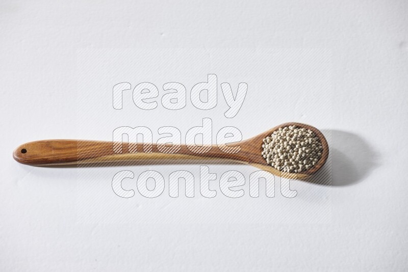 White pepper in a ladle