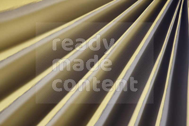An image presenting an abstract paper pattern of lines in white and gold tones