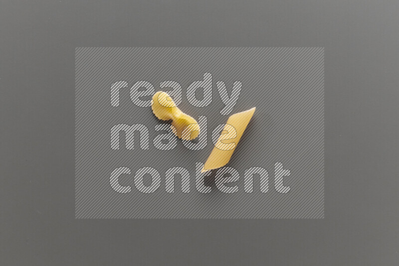 Fiocchi pasta with other types of pasta on grey background