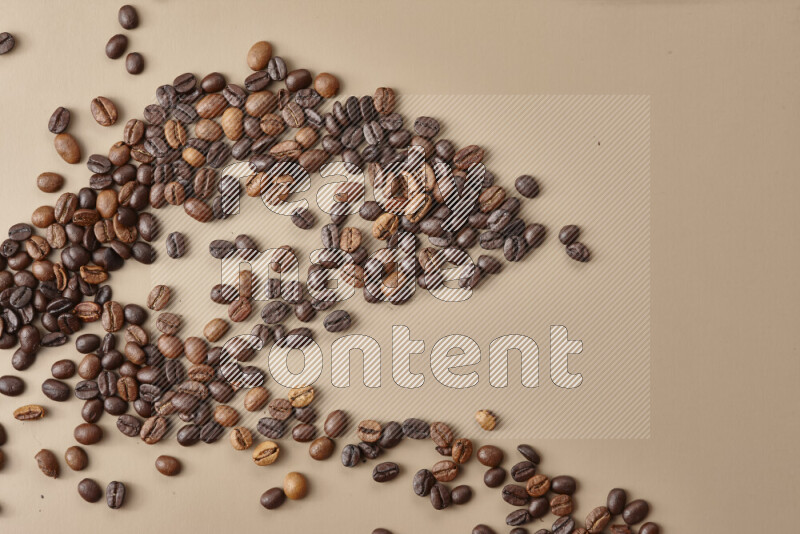 Roasted coffee beans on beige background