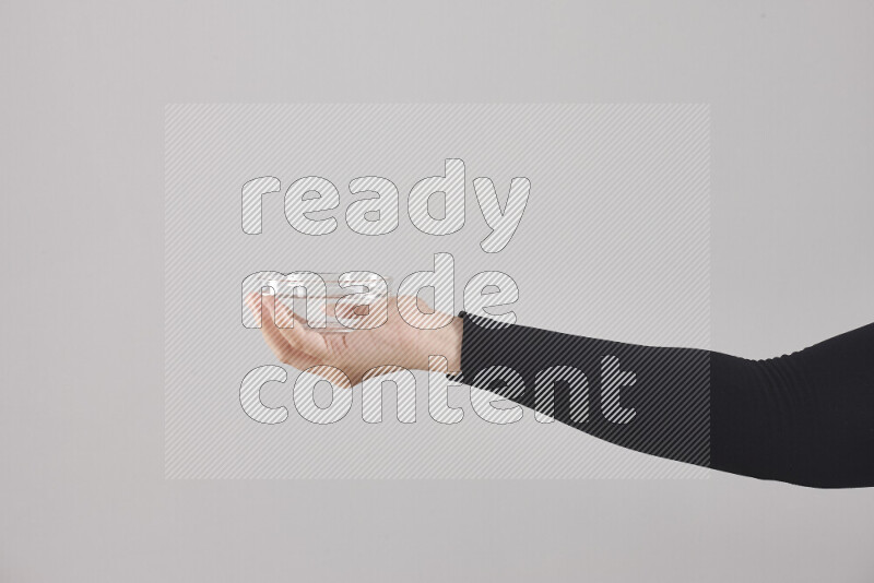 A woman in black abaya holding different glassware in different positions
