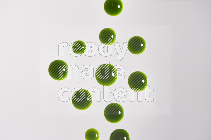 Close-ups of abstract green paint droplets on the surface