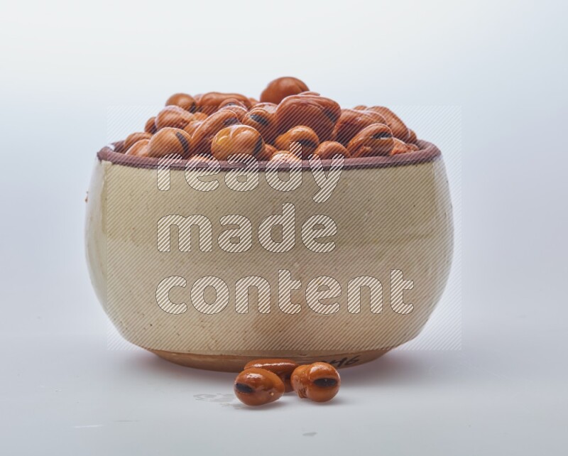Close up shot of cooked fava beans (foul) in a container on white background
