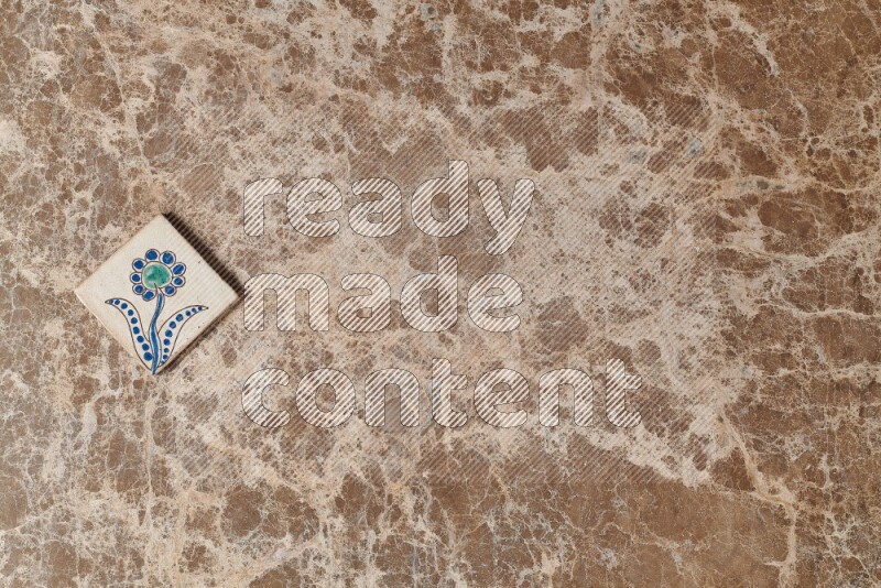 A decorative coaster on beige marble background
