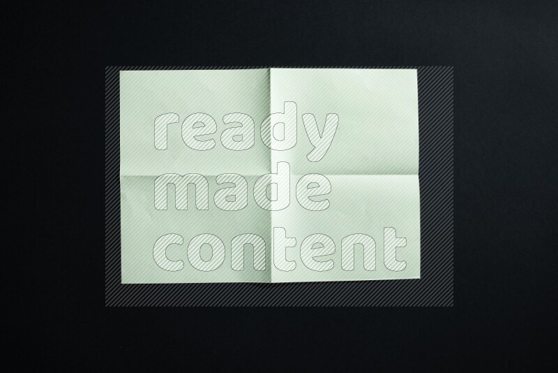Green paper sheet on black background