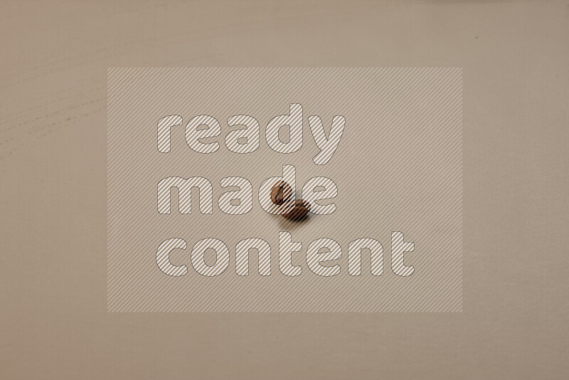 Roasted coffee beans on beige background