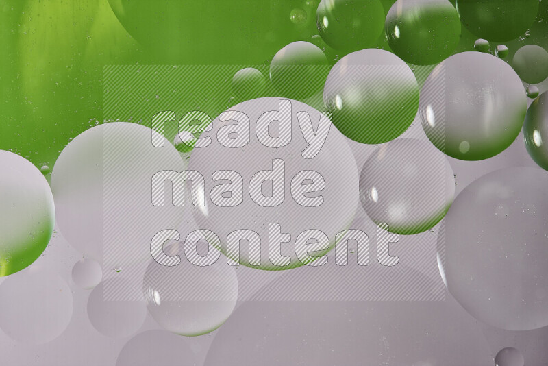 Close-ups of abstract oil bubbles on water surface in shades of white and green
