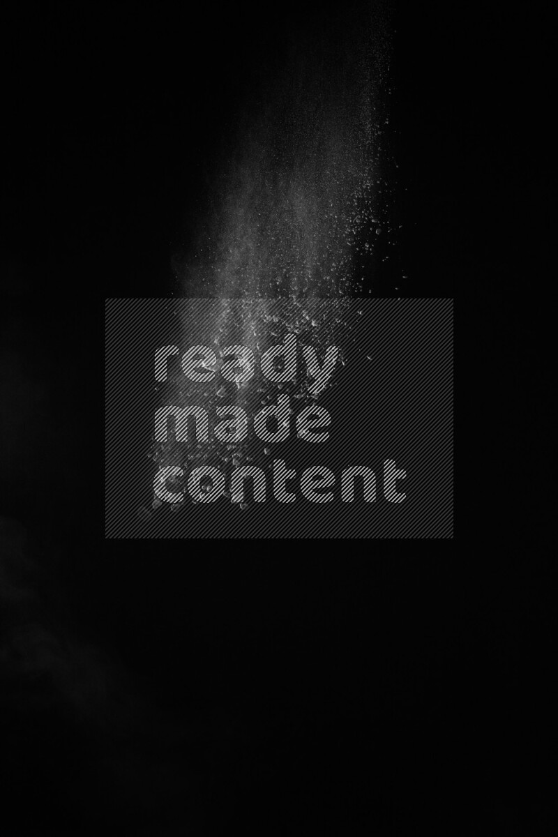 A side view of white powder explosion on black background