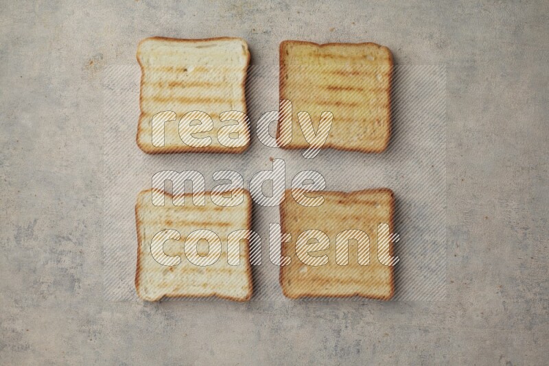 Toasted white Toast slices on a light blue textured background