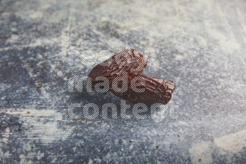 two madjoul dates on a rustic blue backround