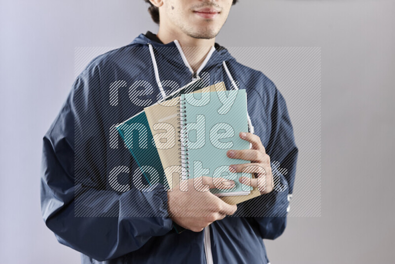 Man holding books and a board in different positions (back to school)