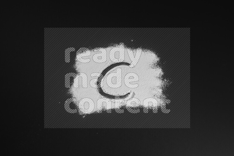 Alphabets written with powder on black background