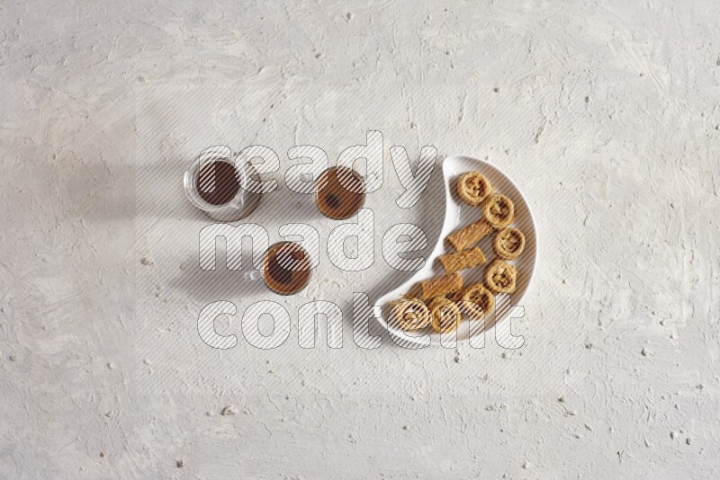 Oriental sweets in a pottery plate with drinks in a light setup
