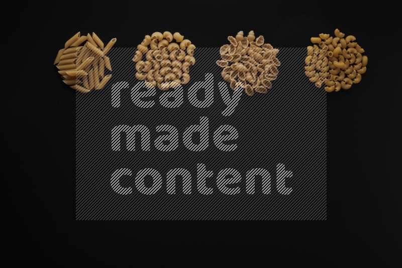 Different pasta types in 4 bunches on black background