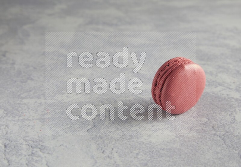 45º Shot of Pink Raspberry macaron on white  marble background