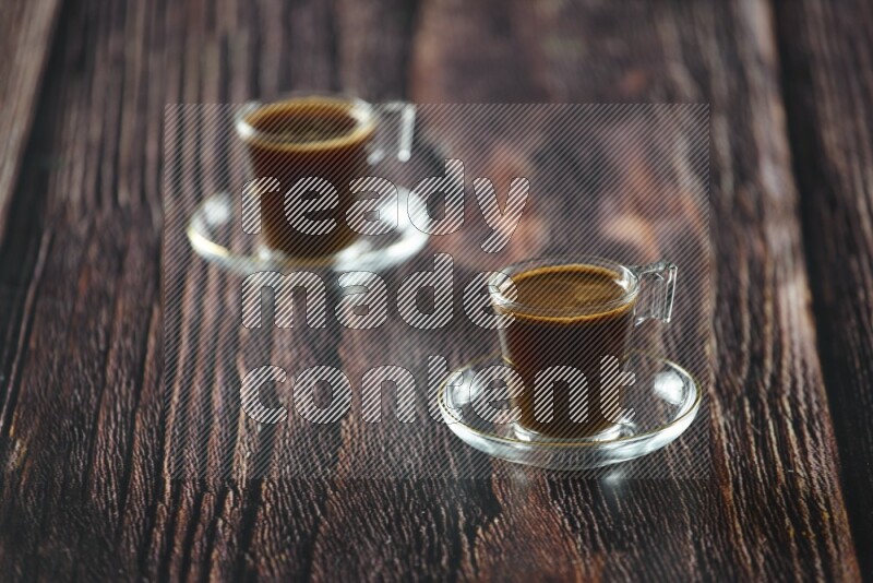 A coffee glass cup with dates and tea on wooden background