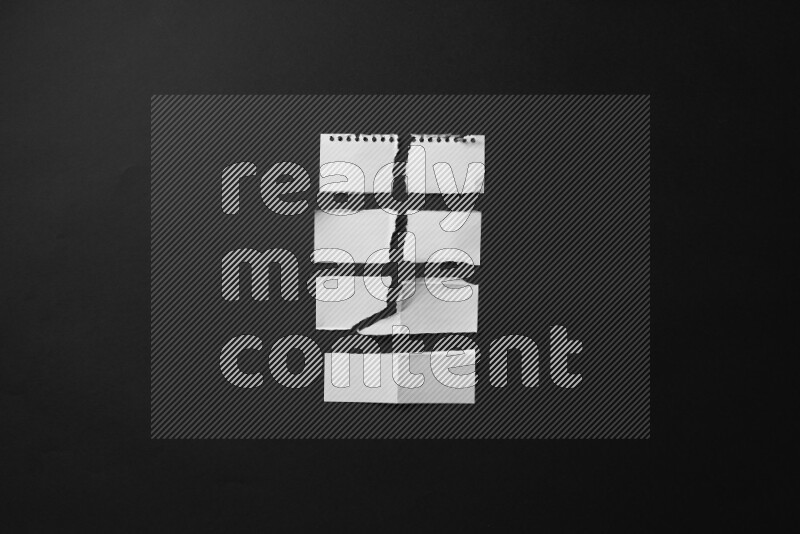 Ripped notebook sheet on black background