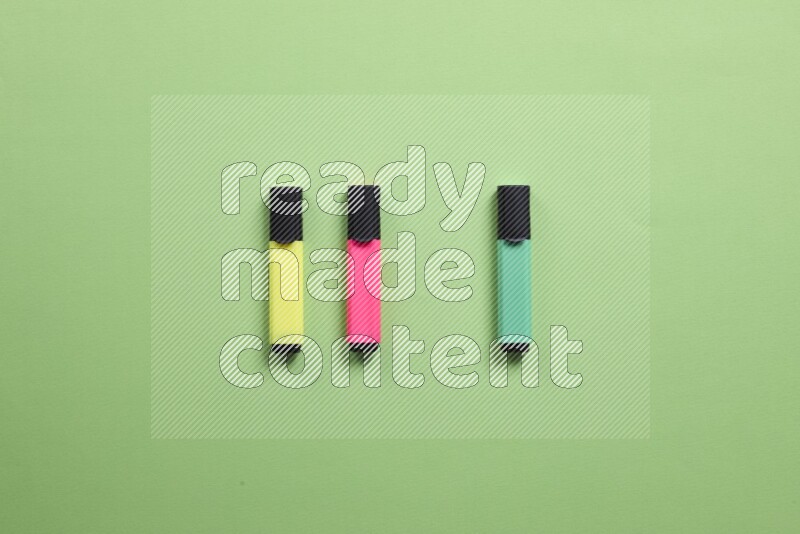 Multicolored highlighter pens on green background