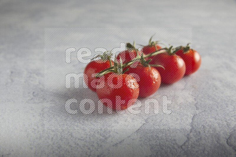 Red cherry tomato vein on a light grey textured background 45 degree