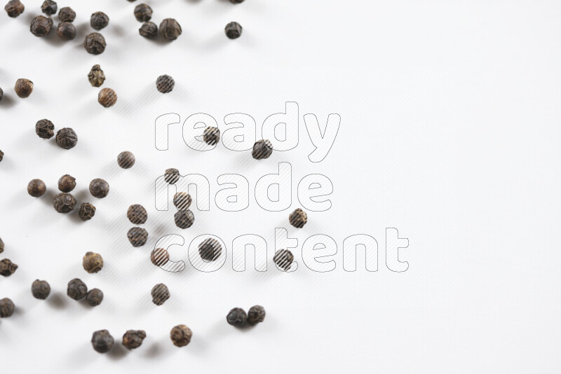 Black pepper beads on white background