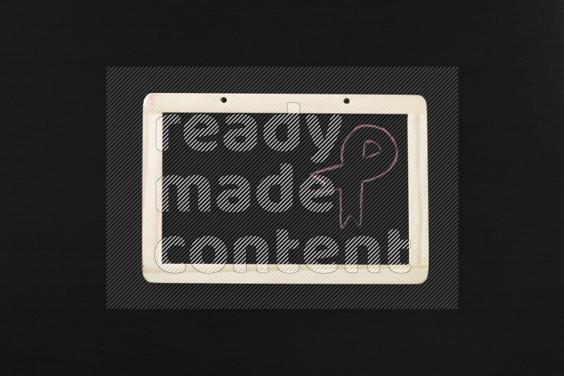 A drawing of pink ribbon on blackboard on black background