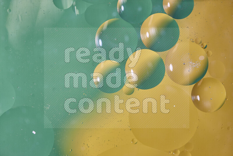 Close-ups of abstract oil bubbles on water surface in shades of green and yellow