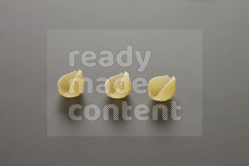 Shells pasta on grey background