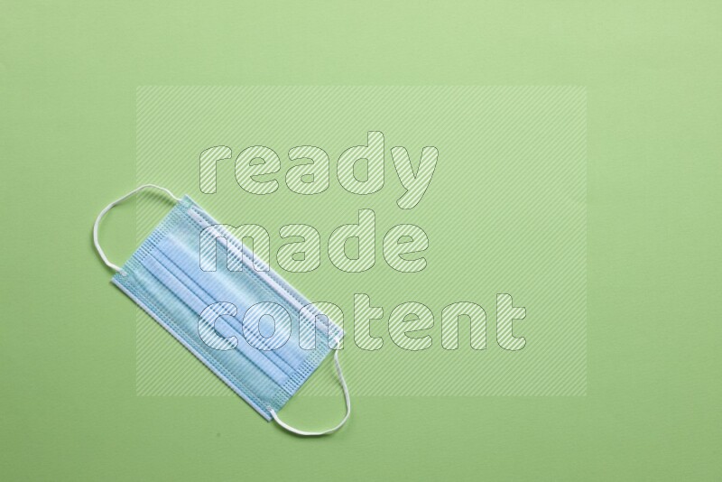 A face mask on green background