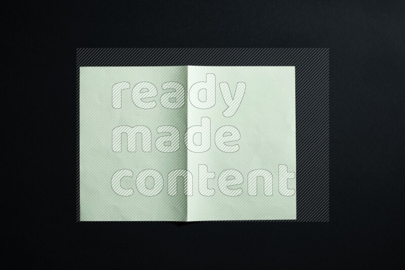 Green paper sheet on black background