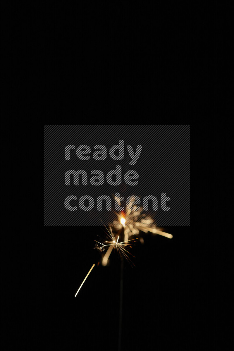 A close-up image of sparkler candle isolated on black background