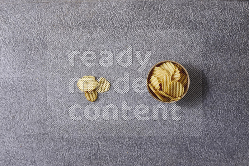 Assorted snacks in pottery bowls on grey background