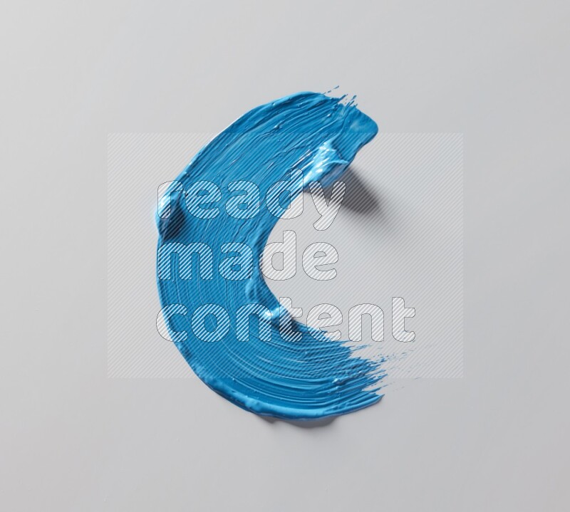 A single blue curved brush stroke on a white background