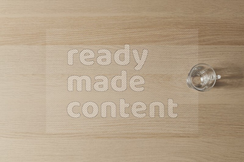 An empty glass cup on light wooden background