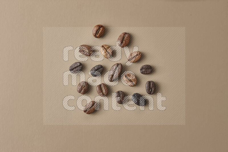 Roasted coffee beans on beige background