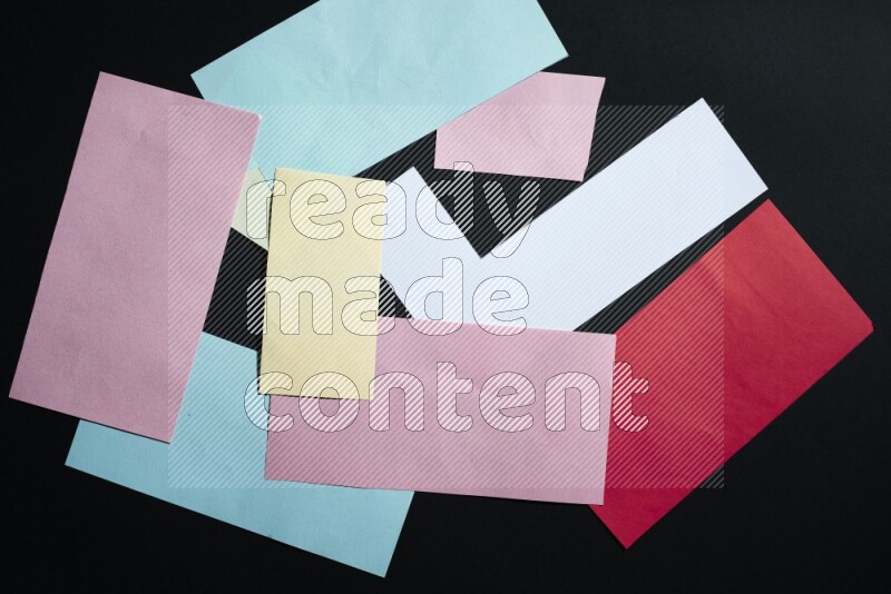 Multicolored paper sheet on black background