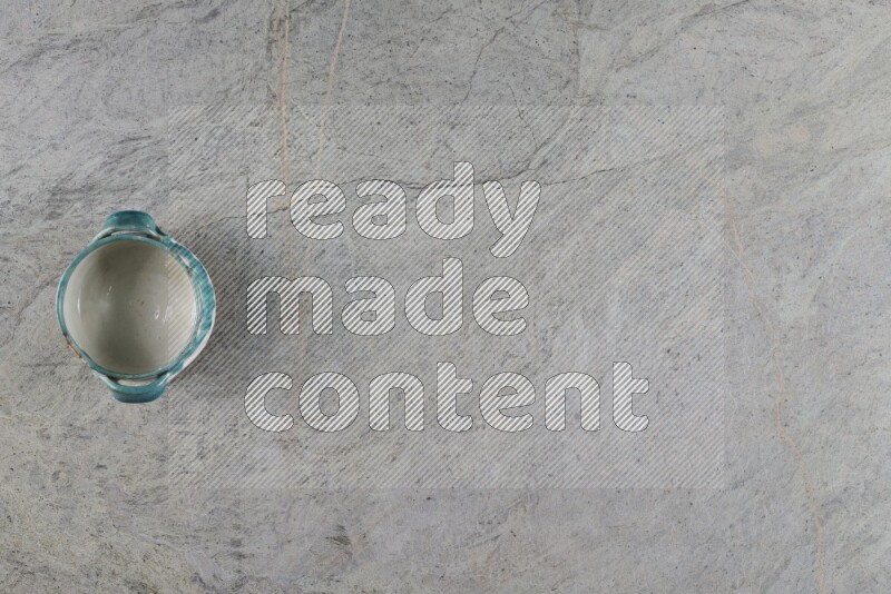 A multicolored pottery Bowl on grey marble background