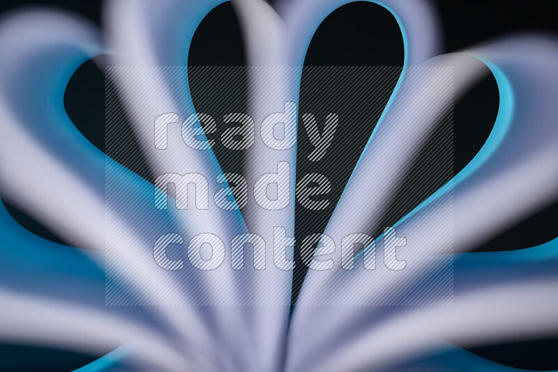 An abstract art piece displaying smooth curves in white and blue gradients created by colored light