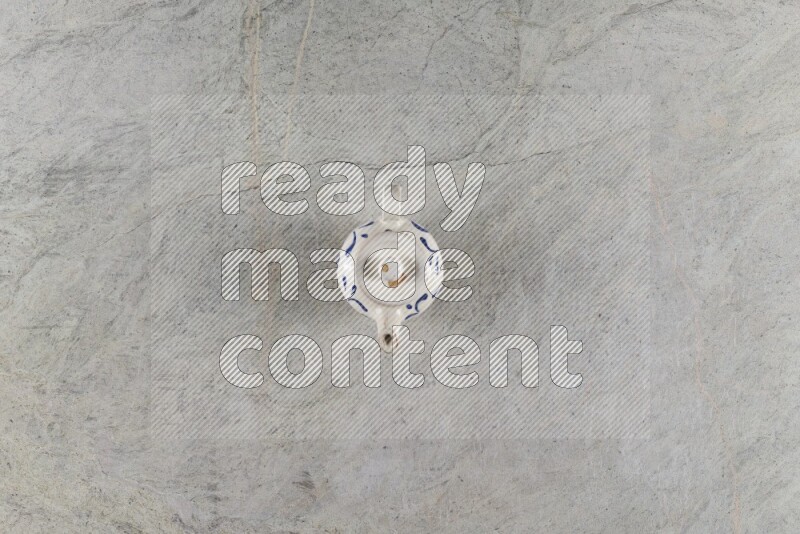A pottery teapot on grey marble background