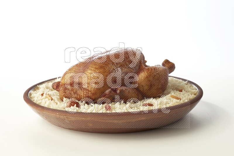 white  basmati Rice with  whole roasted chicken    on a pottery plate  direct  on white background