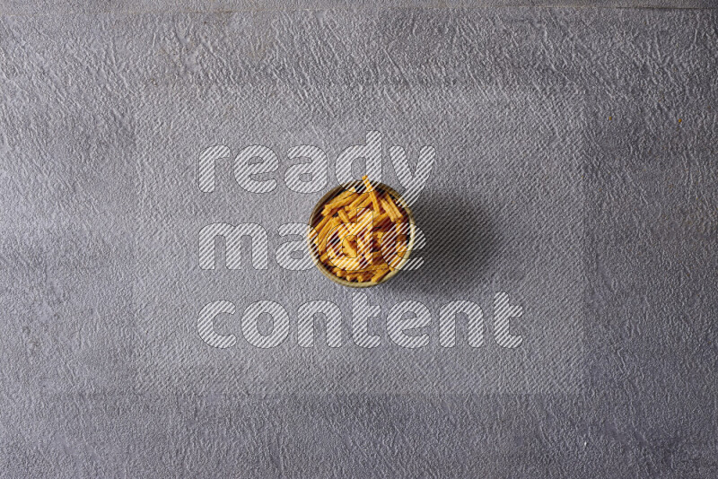 Assorted snacks in pottery bowls on grey background