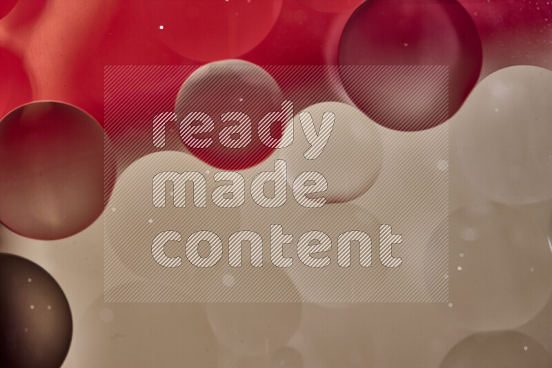 Close-ups of abstract oil bubbles on water surface in shades of red and brown