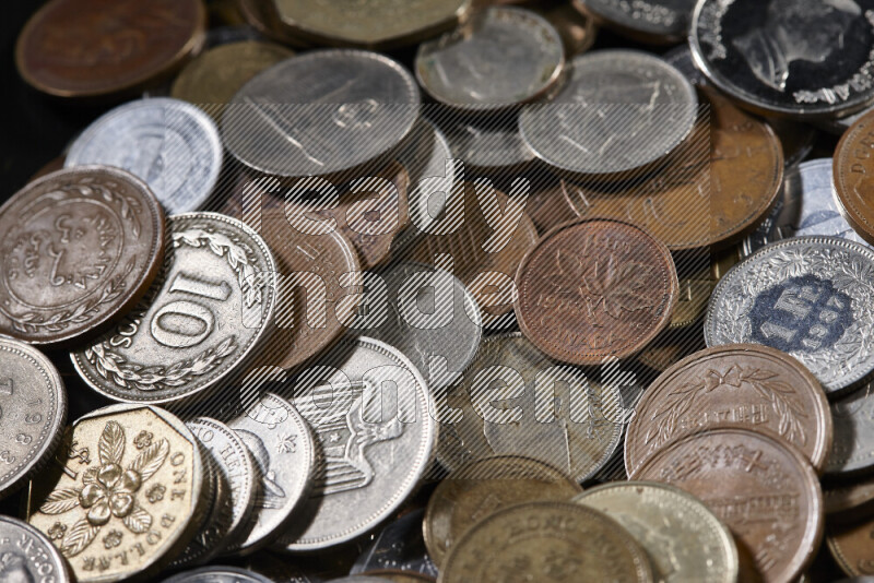 A close-ups of random old coins on black background