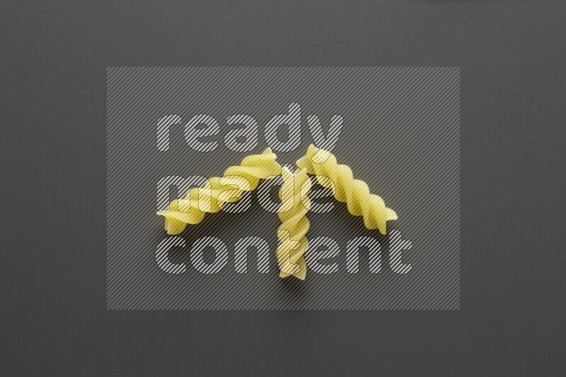 Fusilli pasta on grey background