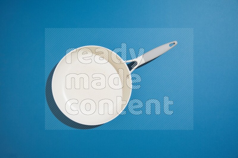 white pan on blue background