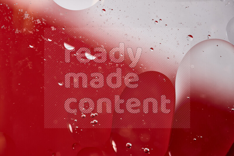 Close-ups of abstract oil bubbles on water surface in shades of white and red