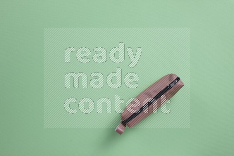 Different school supplies on green background