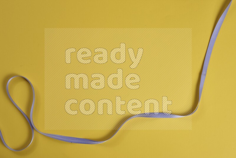 A purple collection of sewing and tailoring tools arranged on a yellow background