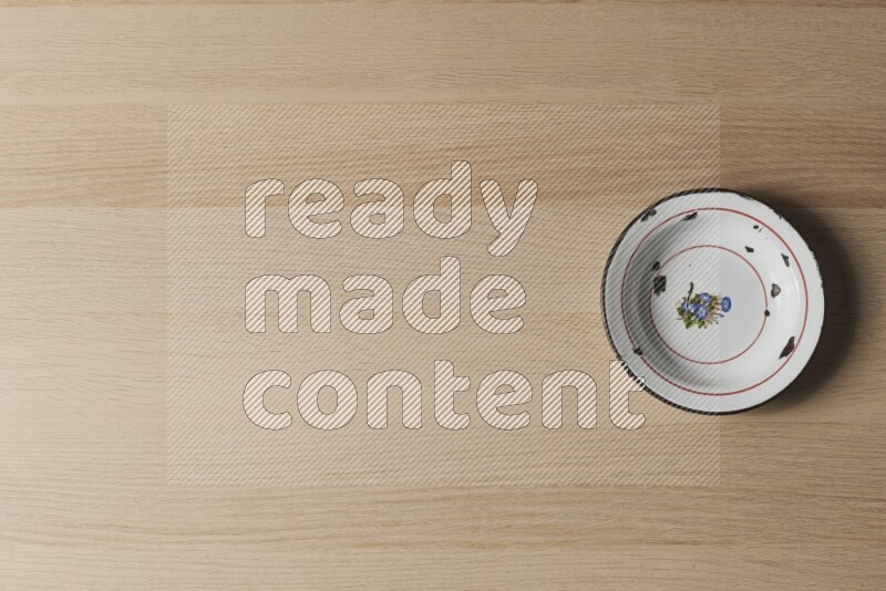 A vintage metal plate on light wooden background