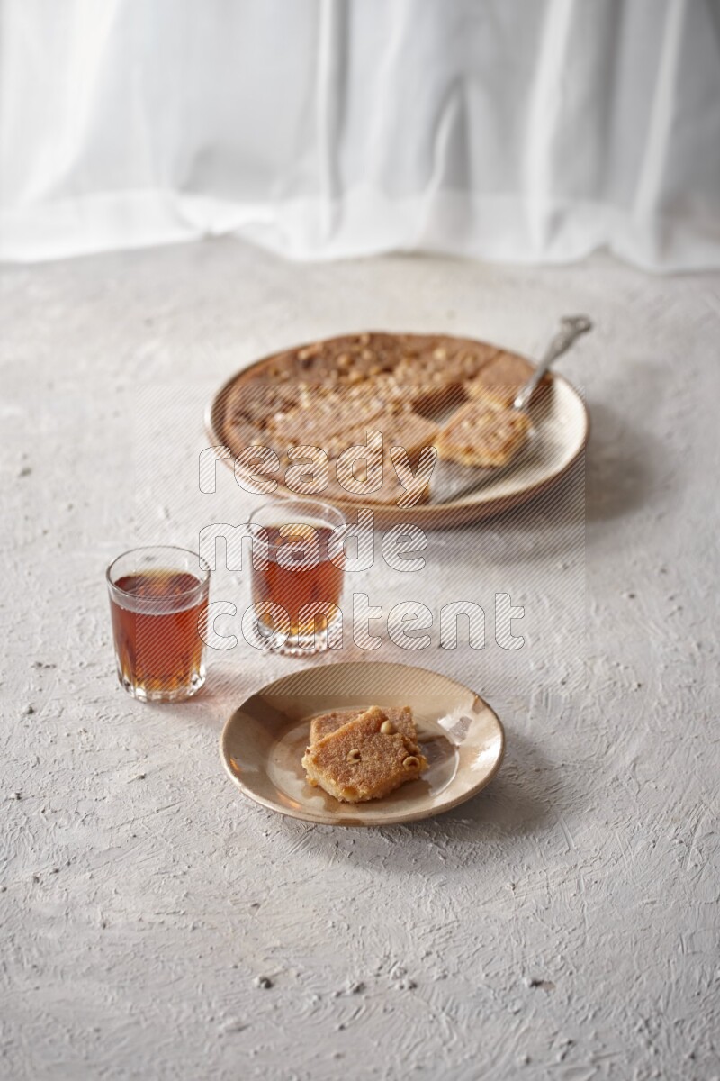 Basbousa with tea in a light setup