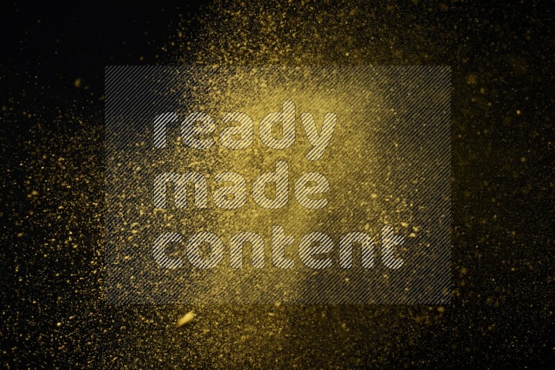 Yellow powder explosion on black background